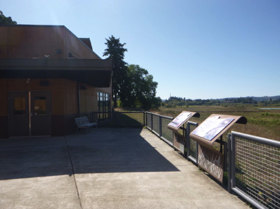 Refuge viewing area on the right rear side of Wildlife Center - bench under overhang - interpretive displays